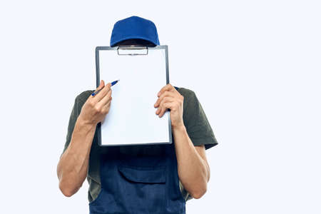 man in working uniform documents delivery loader transportation light backgroundの写真素材