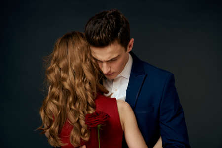 Beautiful couple charm hug lifestyle relationship rose luxury dark backgroundの写真素材