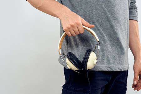 Man holding headphones in the hands of a man lifestyle modern style technology cropped view