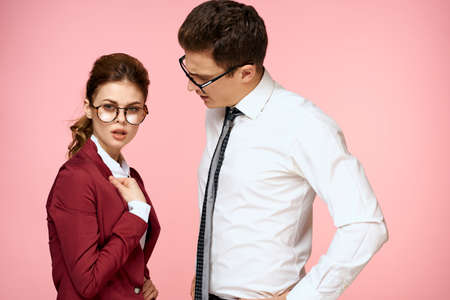 business man and woman office work colleagues team office management studio pink backgroundの写真素材