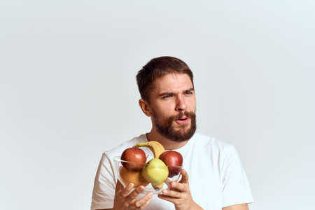 man with fresh fruit in a glass cup gesturing with hands vitamins health energy model bushy beard mustacheの写真素材