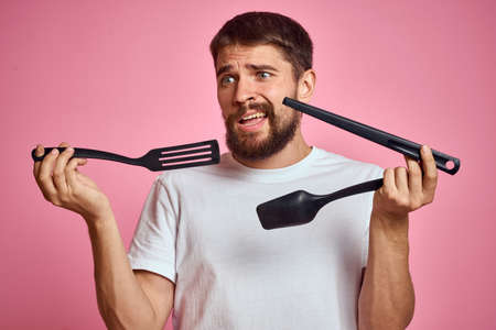 sad man with kitchen tools in hands scoop scoop emotions