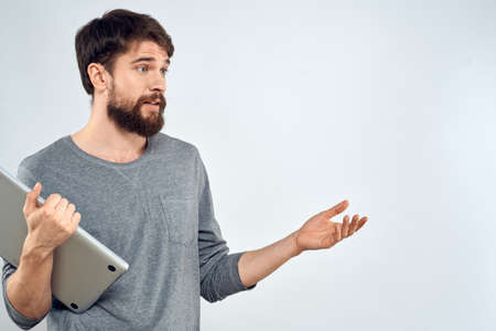 Man with laptop in hands technology internet self-confidence light backgroundの写真素材