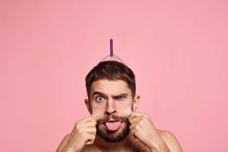 man with head massager relax body care pink backgroundの写真素材