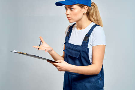 Working woman in uniform courier delivery service documents