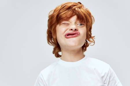 redhead boy grimacing cropped view studioの写真素材