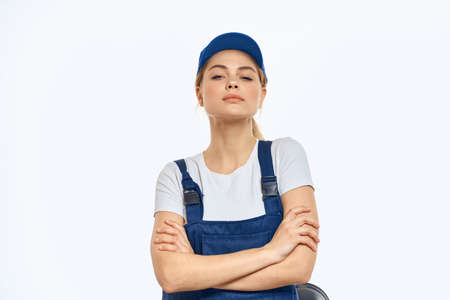 Working woman in blue cap uniform lifestyle emotions service light backgroundの写真素材
