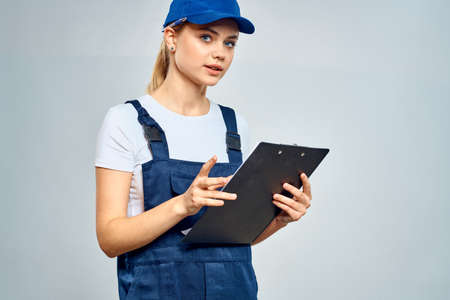 Working woman in uniform courier delivery service documentsの写真素材