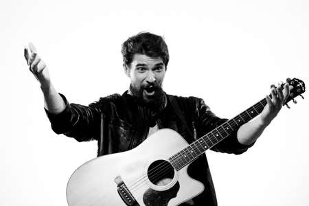 Emotional man with guitar music black leather jacket lifestyle light background