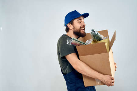 Male worker loading delivery boxes in hands packing lifestyleの写真素材