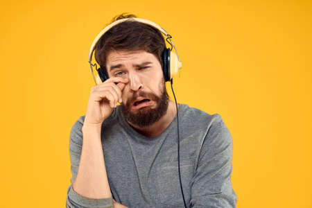 Man with headphones music lifestyle lifestyle technology yellow backgroundの写真素材