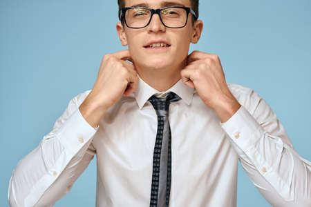 Business man white shirt tie glasses self-confidence official blue backgroundの写真素材