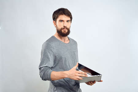 Emotional man holding a laptop success modern style work light background