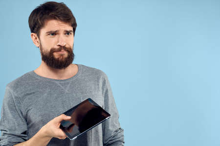 Man with tablet in hands technology lifestyle wireless device blue background