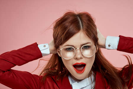 Elegant woman wearing glasses red lips jacket long hair pink