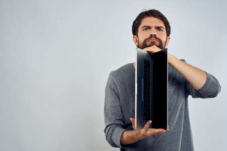 man holding laptop technology internet work communication light backgroundの写真素材