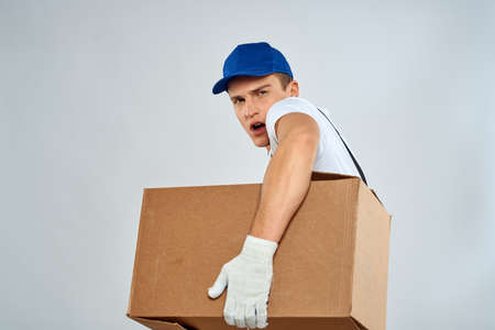 Man worker with box in hands delivery loading service packing serviceの写真素材