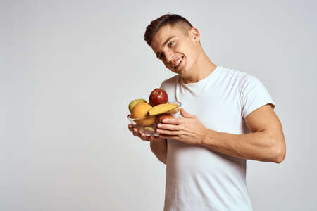 Man with fresh fruit in a cup health lifestyle healthy nutrition vitaminsの写真素材