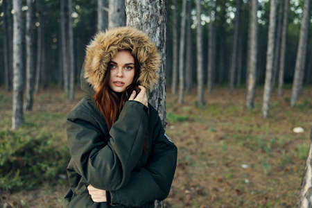 Woman in hooded jacket near tree travel nature lifestyleの写真素材