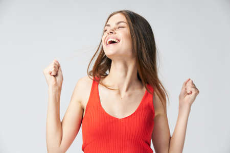 Woman in red t-shirt closed eyes smileの写真素材