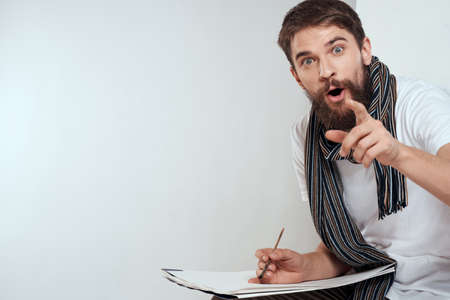 Male artist sitting on chair drawing brush easel hobby Creative light background