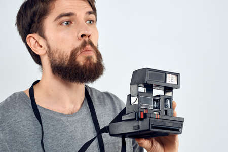 male photographer holding camera professional lens creative studio work light backgroundの写真素材