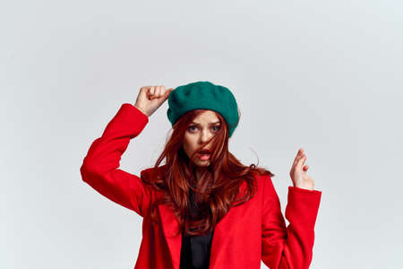 Woman in red coat and in green hat on isolated background cropped model with Copy Space emotionsの写真素材