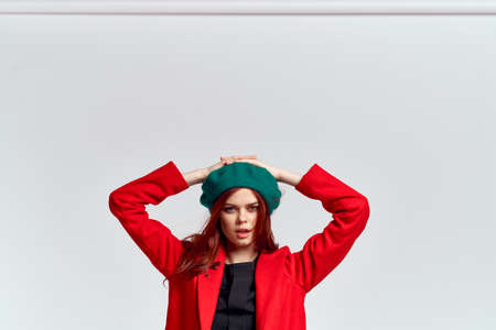 Woman in red coat and in green hat on isolated background cropped model with Copy Space emotionsの写真素材