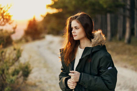 woman in jacket on nature travel outdoors freedom