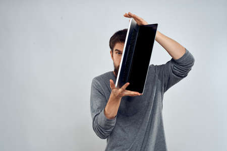 man holding laptop technology internet work communication light backgroundの写真素材