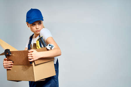 Working woman box with tools courier delivery workの写真素材