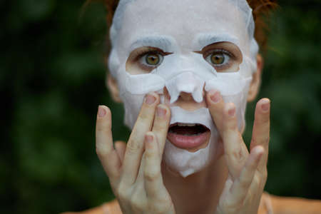 Nice woman white mask Wide open eyes skin careの写真素材