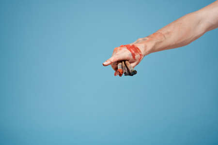 Artists hands paint close-up blue background drawing hobby