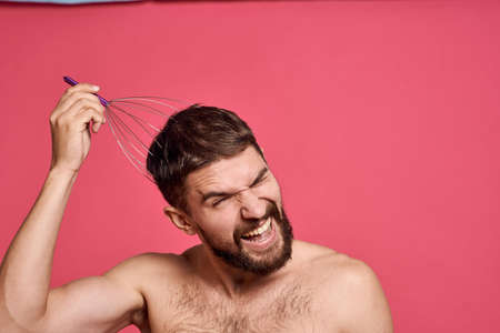 man with head massager relax body care pink backgroundの写真素材