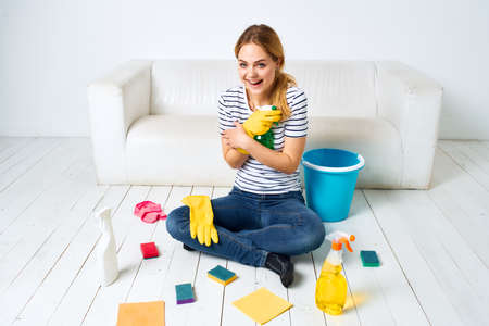 Woman with detergent in hands housework interior hygiene