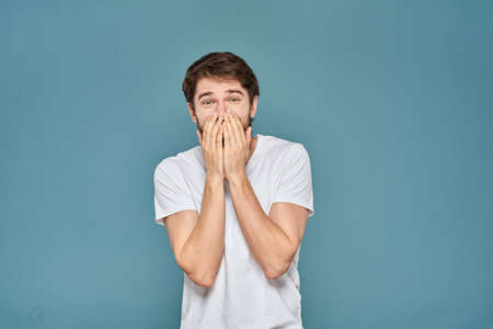 man in white t-shirt gesturing with his hands studio cropped