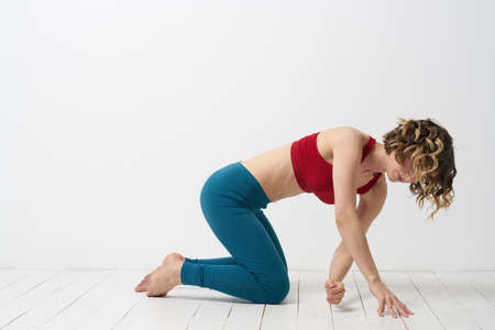 woman in leggings is engaged in gymnastics in a light room slim figure fitness sport