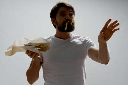 Potato in a package and outraged male cropped viewの写真素材