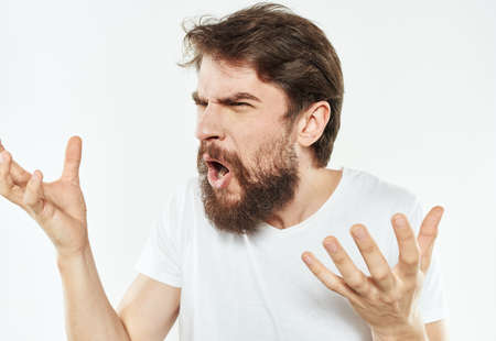 Young man in white t-shirt emotions model gesturing with hands