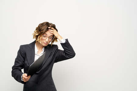 Woman in business suit finances work documents glasses hairstyle