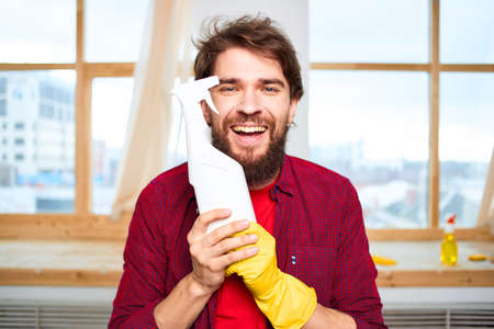 Cheerful man cleaning detergent homework hygiene interior