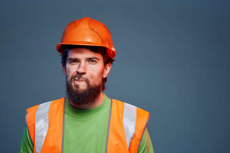 bearded man orange helmet construction professional hard workの写真素材