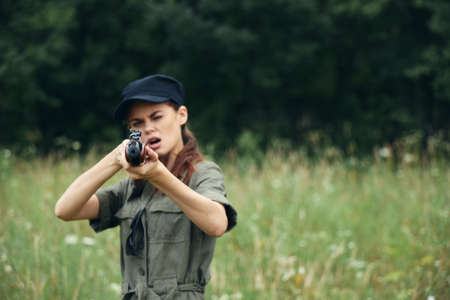Woman soldier Weapon in hand sight forward hunting fresh airの写真素材
