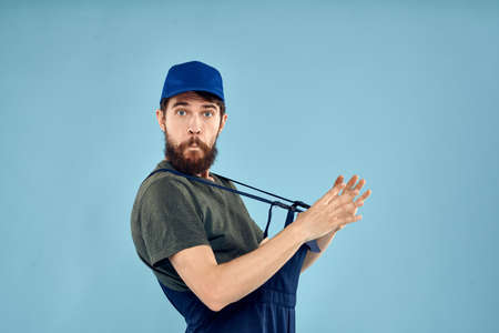 man in work uniform uniform professional work lifestyle delivery service blue backgroundの写真素材