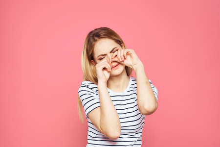 Woman in striped t-shirt emotions studio cropped view lifestyle pink isolated backgroundの写真素材