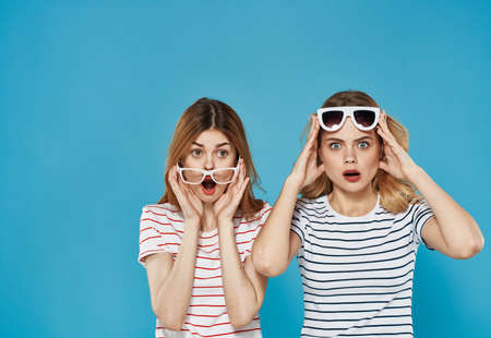 Cheerful girlfriend emotions surprise sunglasses cropped view blue background communication