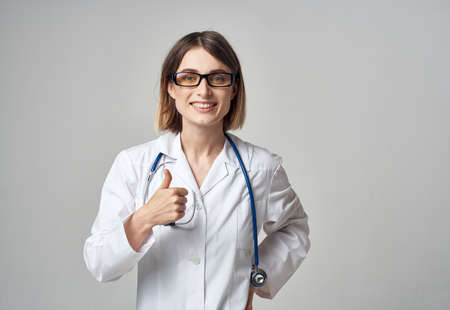woman doctor with stethoscope gesturing with hands emotions glasses modelの写真素材
