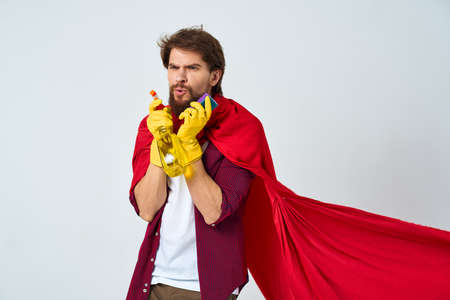 Man in red raincoat rubber gloves cleaning professional homeworkの写真素材