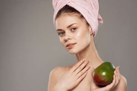 woman with bare shoulders clean health mango skin in hands of spa procedure