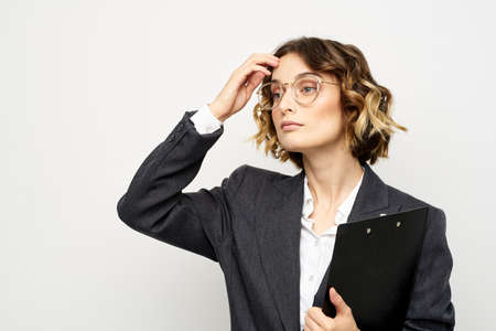 Woman in business suit finances work documents glasses hairstyle